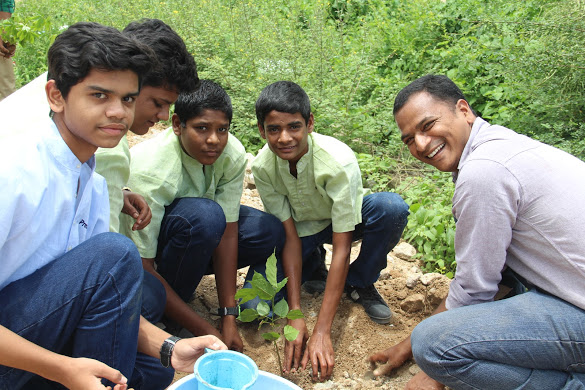 Venkatesh and his students planting 1 of 30 tress